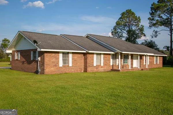 a front view of a house with a garden