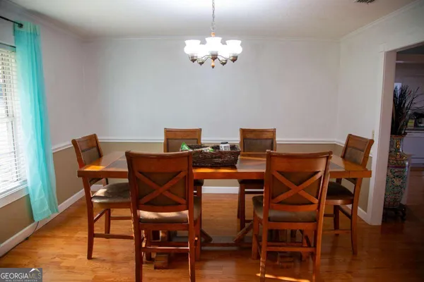 a view of a dining room with furniture and wooden floor