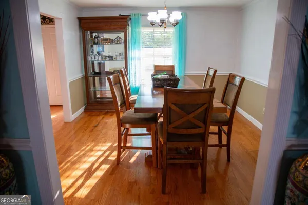 a view of a dining room with furniture and a floor to ceiling window