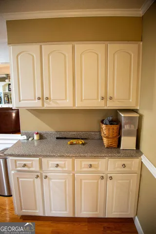 a kitchen with stainless steel appliances granite countertop white cabinets sink and dishwasher