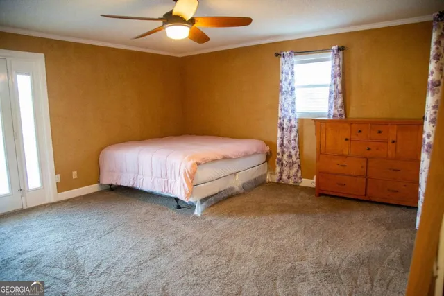 a spacious bedroom with a bed and a dresser