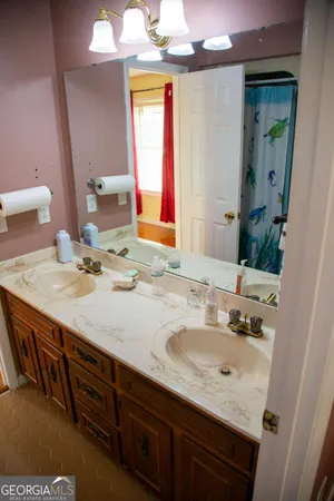 a bathroom with a granite countertop sink and a mirror