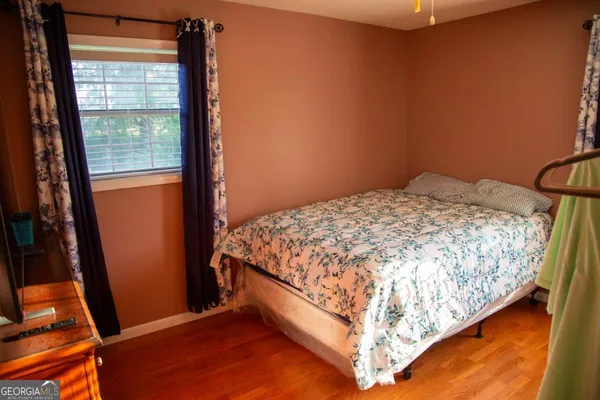 a bed sitting in a bedroom next to a window
