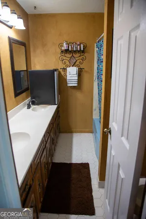 a view of a bathroom with sink and mirror