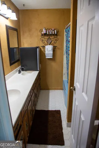 a view of a bathroom with sink and mirror