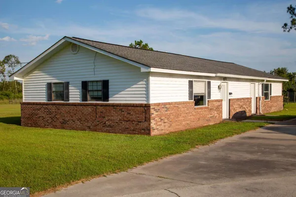 a front view of house with yard and green space