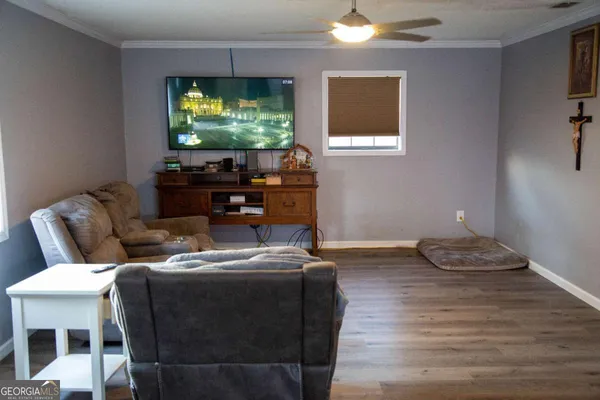 a living room with furniture and a flat screen tv