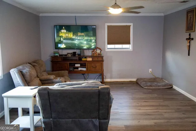 a living room with furniture and a flat screen tv