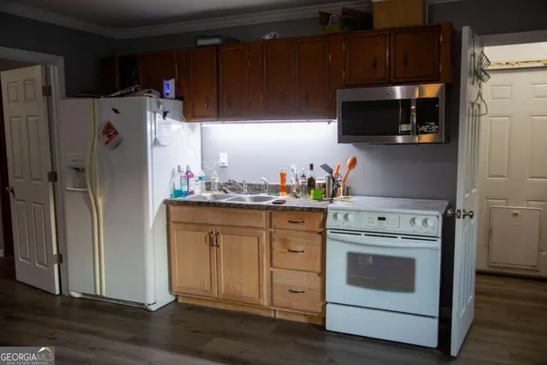 a kitchen with stainless steel appliances a stove microwave and refrigerator