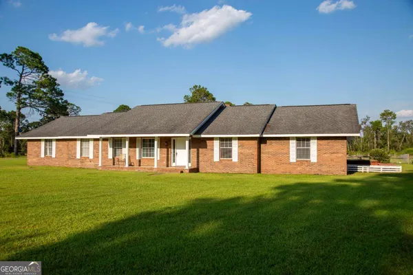 a front view of a house with a garden