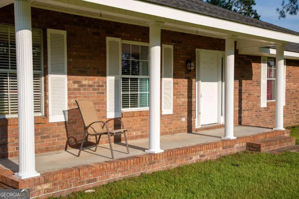a view of a house with backyard and porch