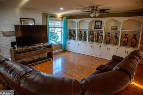 a living room with furniture and a flat screen tv