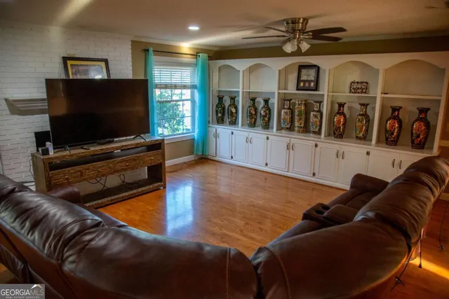a living room with furniture and a flat screen tv