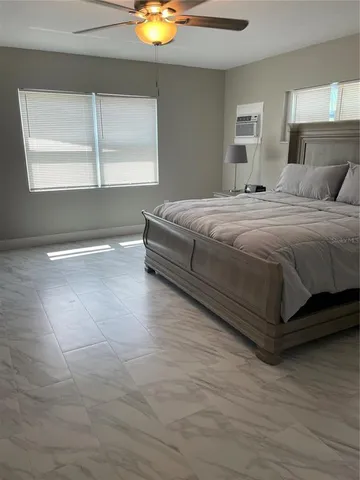 a bedroom with a bed and window