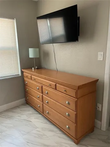 a room with a dresser and a television