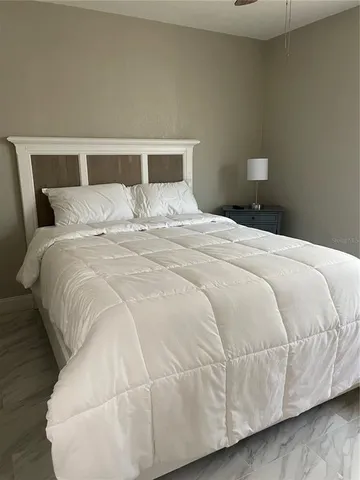 a large white bed in a white room