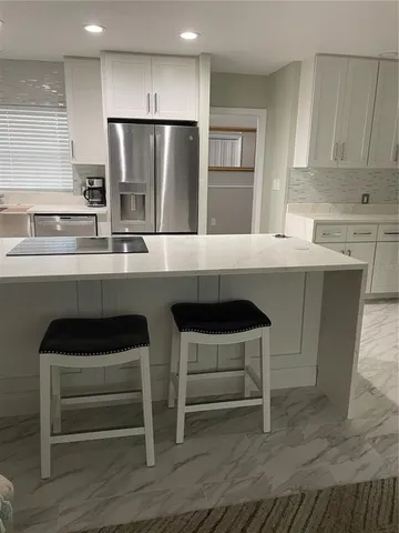 a kitchen with a sink cabinets and stainless steel appliances