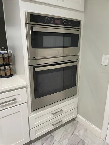 a stove top oven sitting inside of a kitchen
