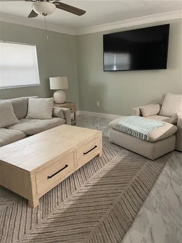 a large bedroom with two beds and a flat screen tv