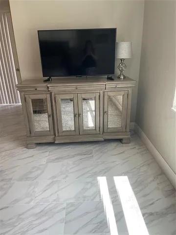 a living room with a flat screen tv and a fireplace