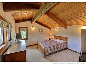 93 U Road Silverthorne, CO 80498 - Photo 13 of 18 a bedroom with a bed a mirror on desk and wooden floor
