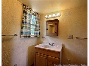 93 U Road Silverthorne, CO 80498 - Photo 14 of 18 a bathroom with a sink a large mirror and a shower