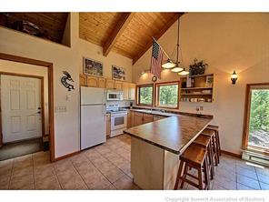 93 U Road Silverthorne, CO 80498 - Photo 6 of 18 a kitchen that has a table and chairs in it