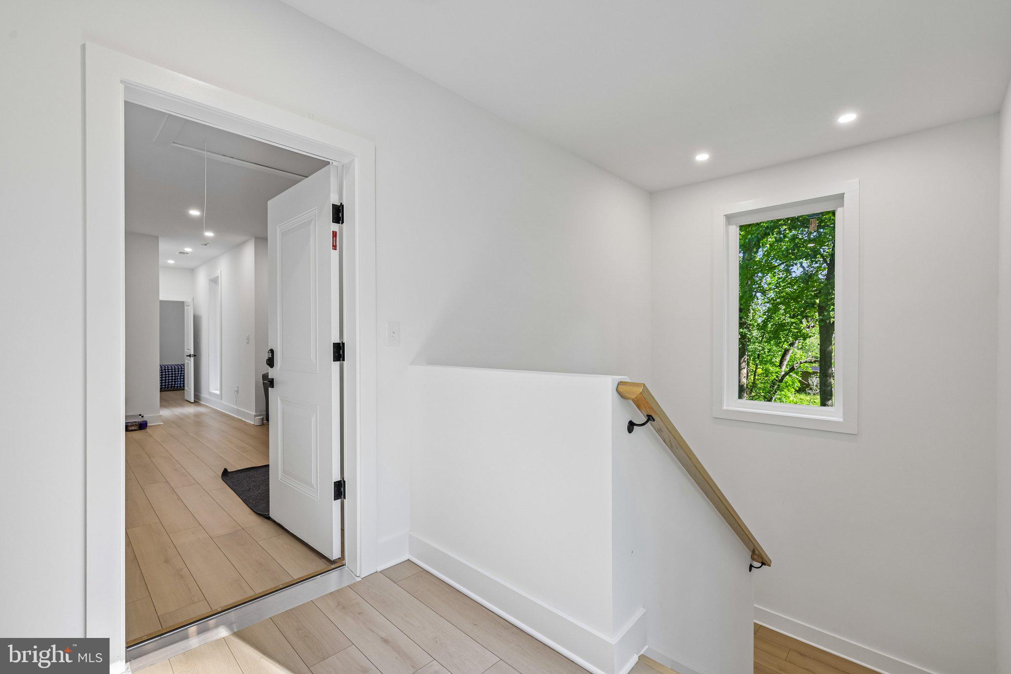 4315 Pinetree Road Rockville, MD 20853 - Photo 19 of 28 a view of a hallway with wooden floor and a living room