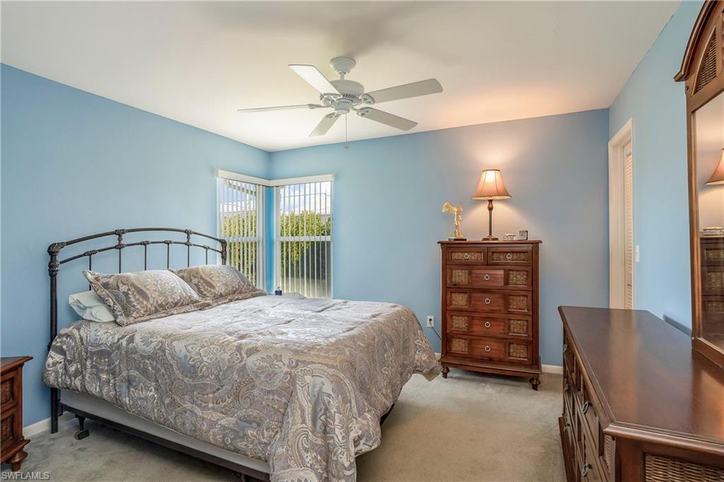 17509 Allentown Road Fort Myers, FL 33967 - Photo 14 of 20 a bedroom with a bed a chandelier and a chair