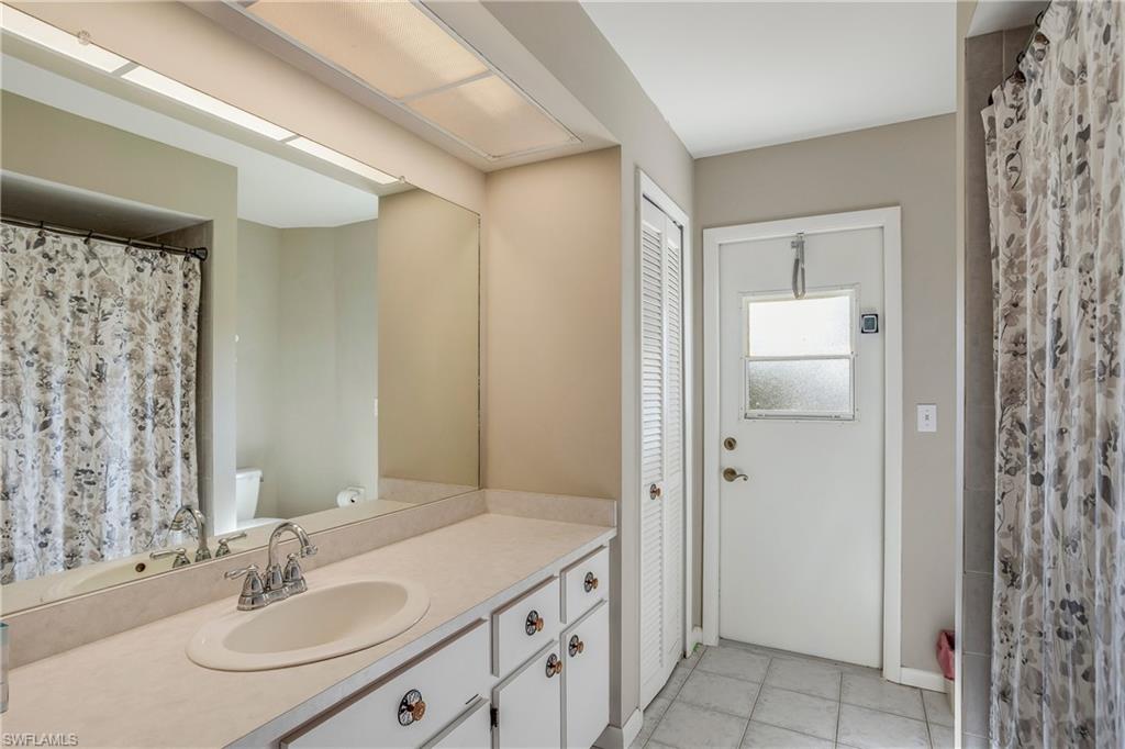 17509 Allentown Road Fort Myers, FL 33967 - Photo 15 of 20 a bathroom with a granite countertop sink a mirror and a shower