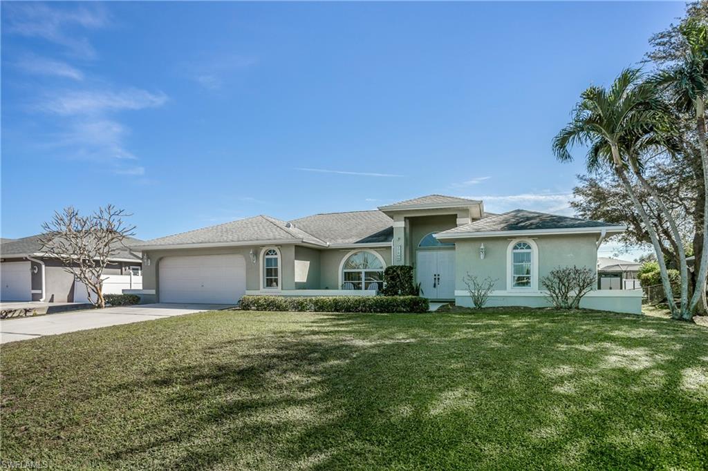 17509 Allentown Road Fort Myers, FL 33967 - Photo 2 of 20 a front view of a house with a garden