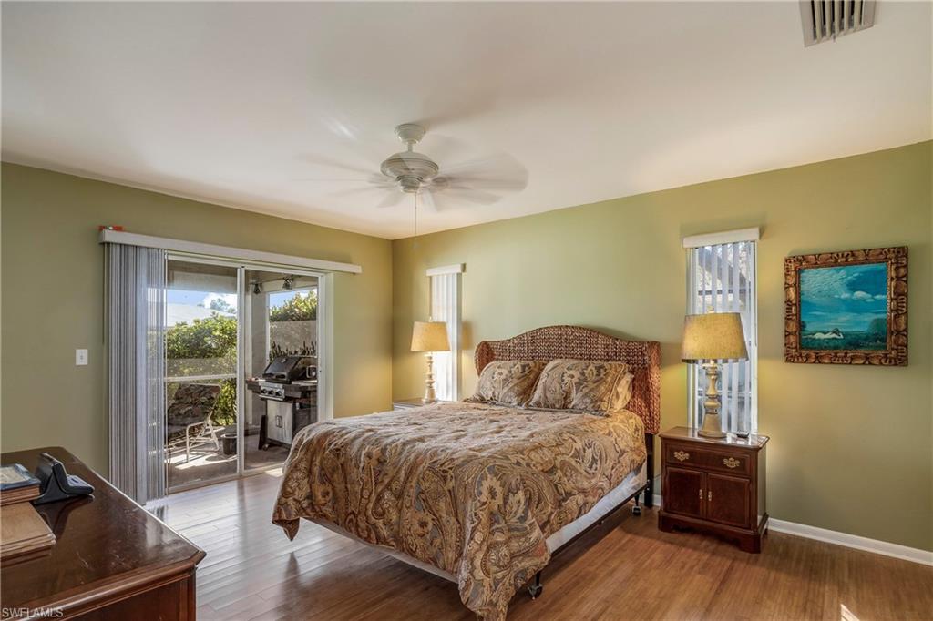 17509 Allentown Road Fort Myers, FL 33967 - Photo 10 of 20 a bedroom with a large bed and a tv