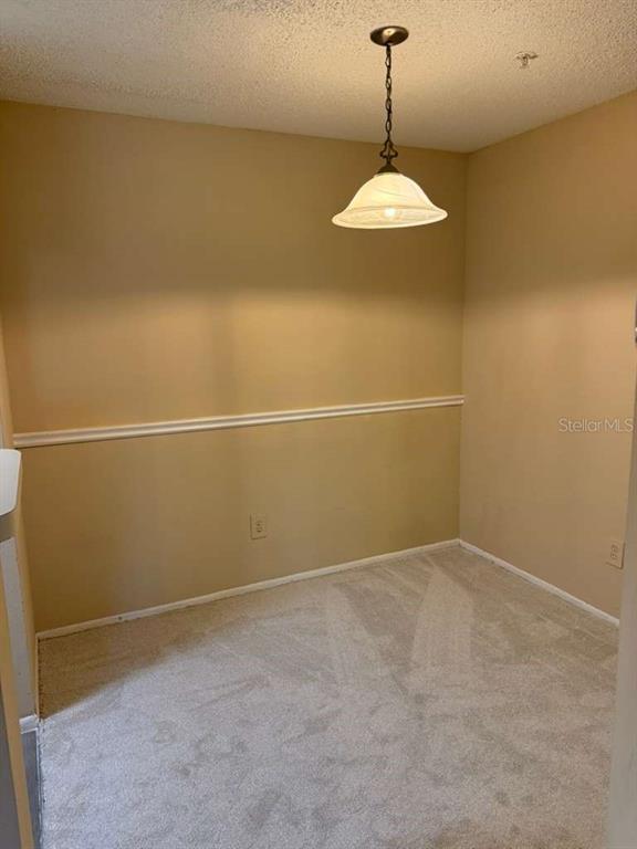 199 Afton Square, Unit 103 Altamonte Springs, FL 32714 - Photo 5 of 21 a view of a room with a ceiling fan and window