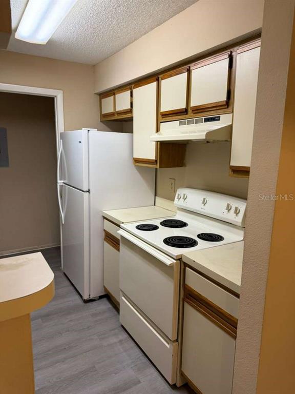 199 Afton Square, Unit 103 Altamonte Springs, FL 32714 - Photo 7 of 21 a kitchen with a stove and a refrigerator