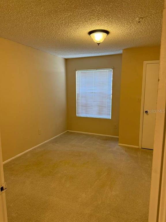 199 Afton Square, Unit 103 Altamonte Springs, FL 32714 - Photo 9 of 21 an empty room with a empty space and windows