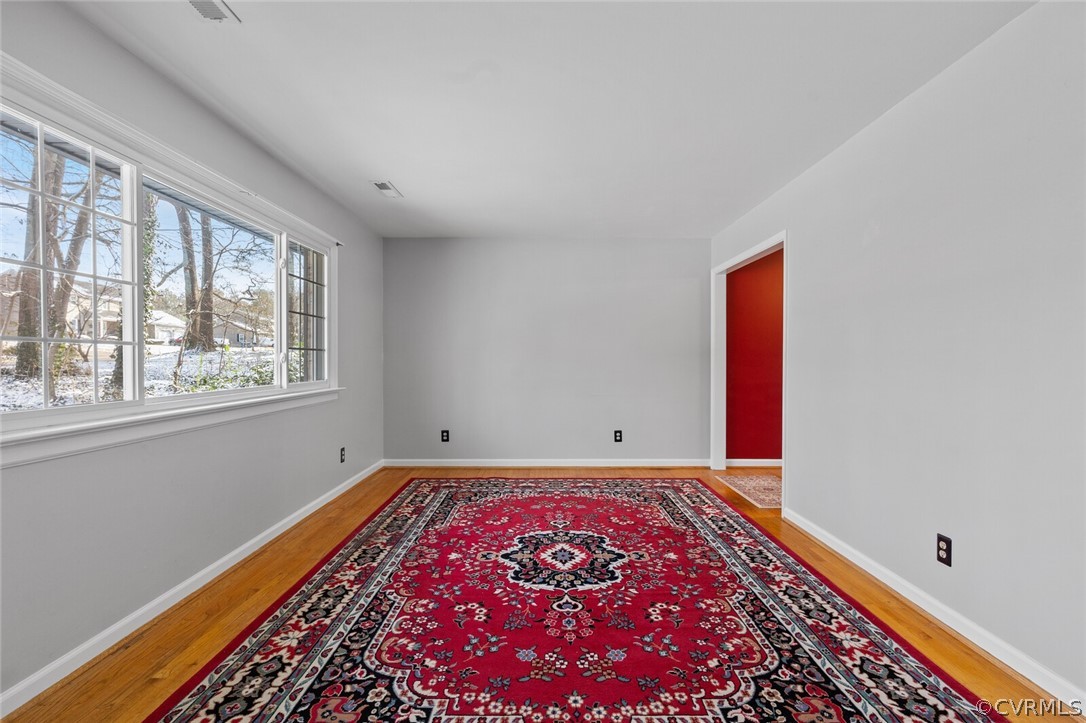 4541 Crossgate Road Chester, VA 23831 - Photo 9 of 47 a view of an empty room with a window and wooden floor