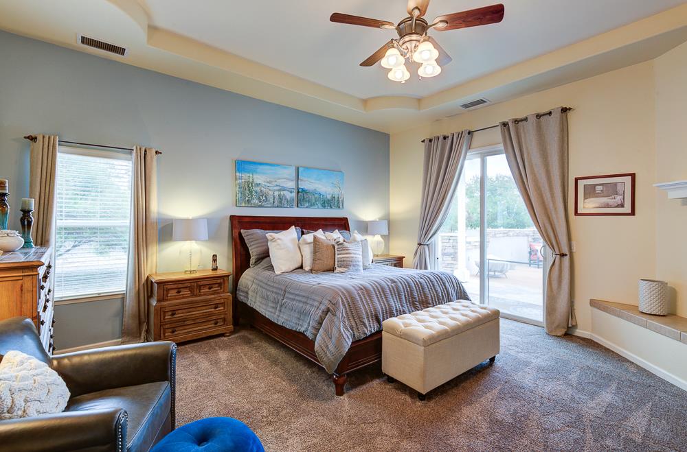 17465 Monreal Road Madera, CA 93636 - Photo 34 of 59 a spacious bedroom with a bed couch and a window
