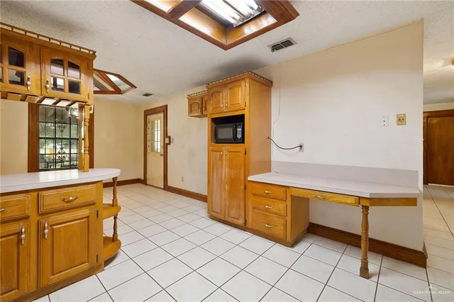 a kitchen with stainless steel appliances granite countertop a refrigerator and a stove