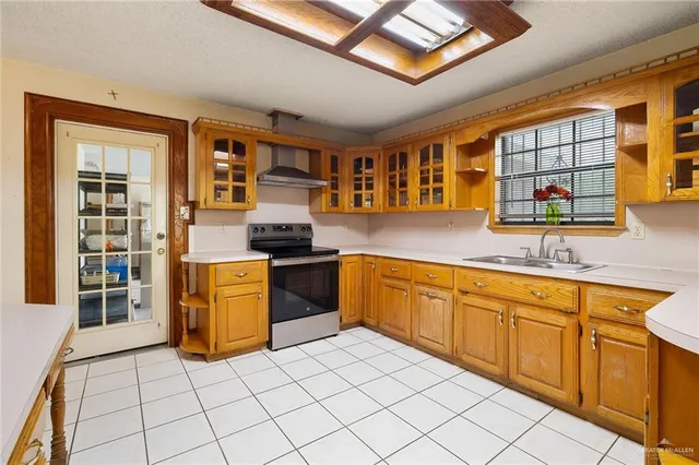 a kitchen with stainless steel appliances granite countertop a stove sink and cabinets