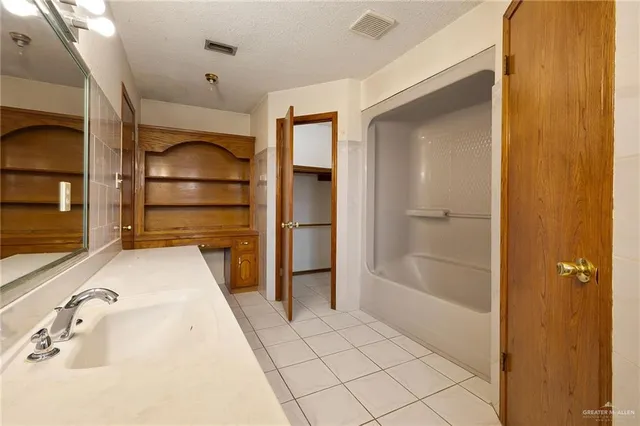 a bathroom with a tub and shower