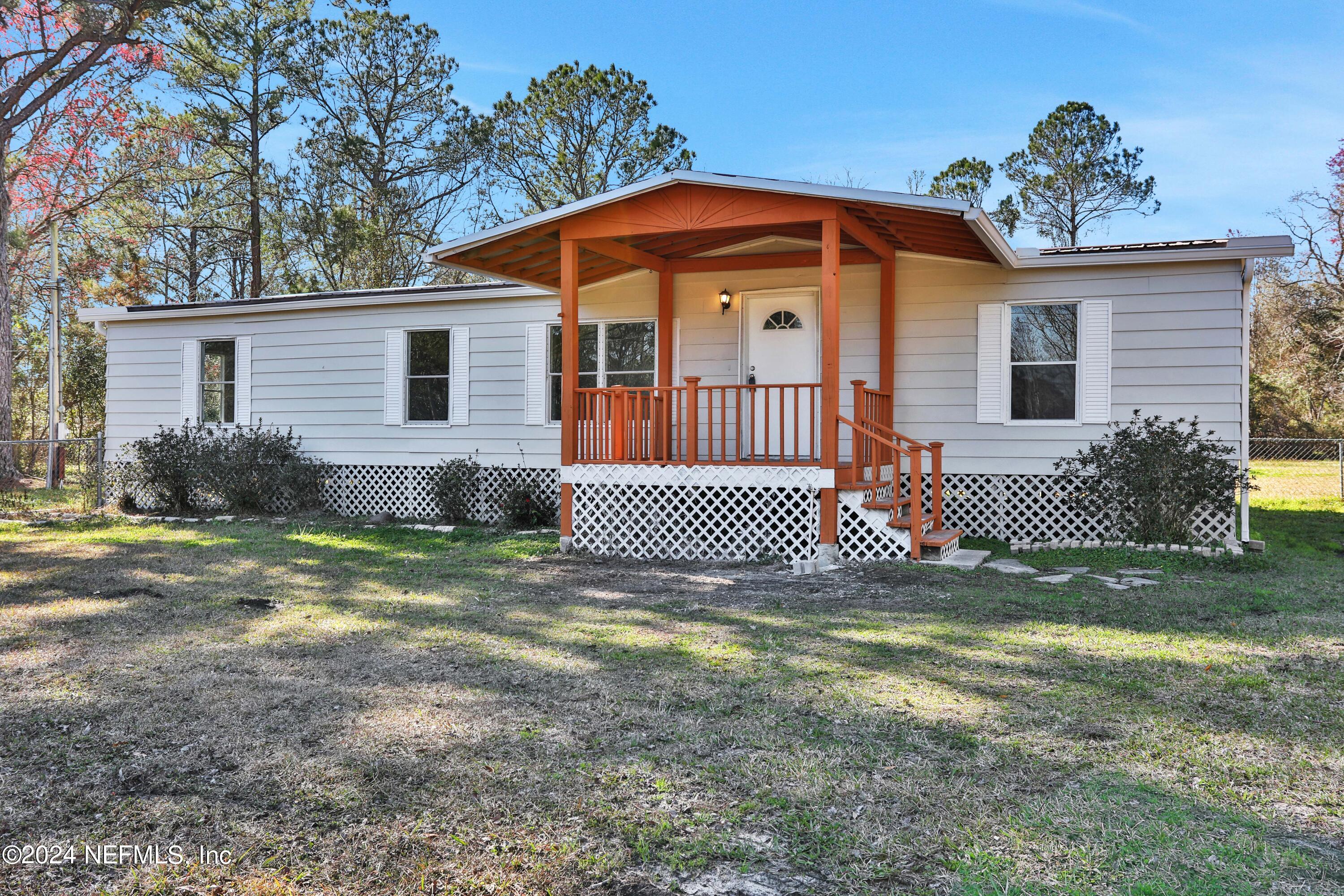 54057 Bea Road Callahan, FL 32011 - Photo 1 of 29 a front view of a house with a yard
