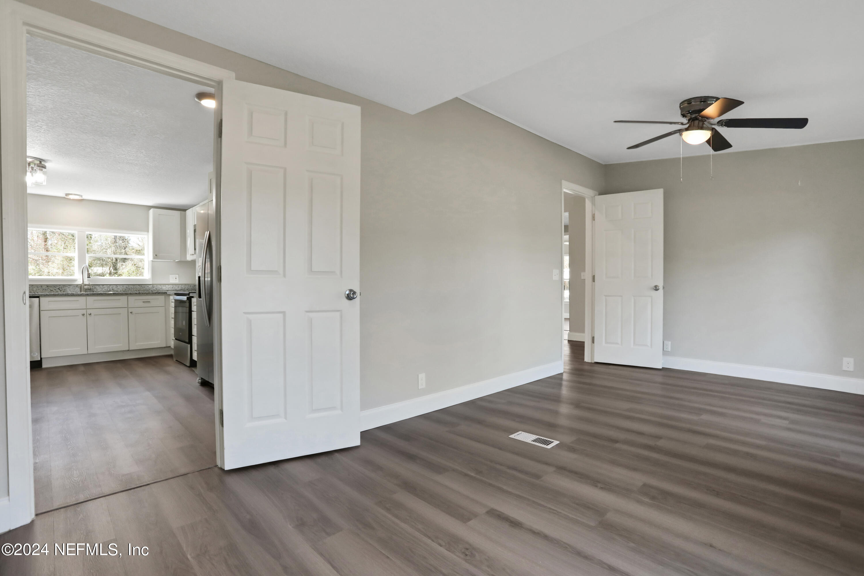 54057 Bea Road Callahan, FL 32011 - Photo 11 of 29 wooden floor in an empty room with a window