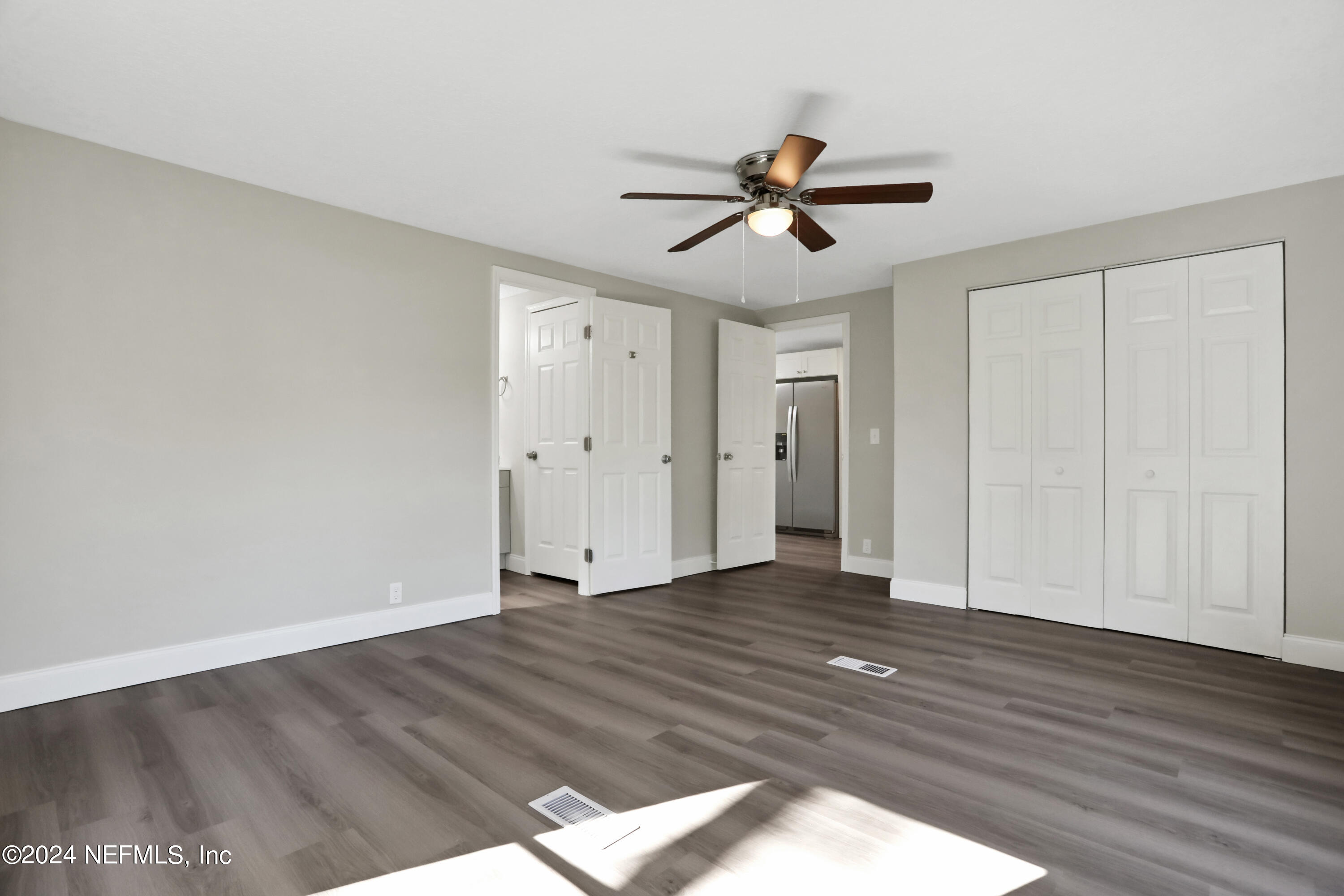 54057 Bea Road Callahan, FL 32011 - Photo 12 of 29 a view of empty room with wooden floor and fan