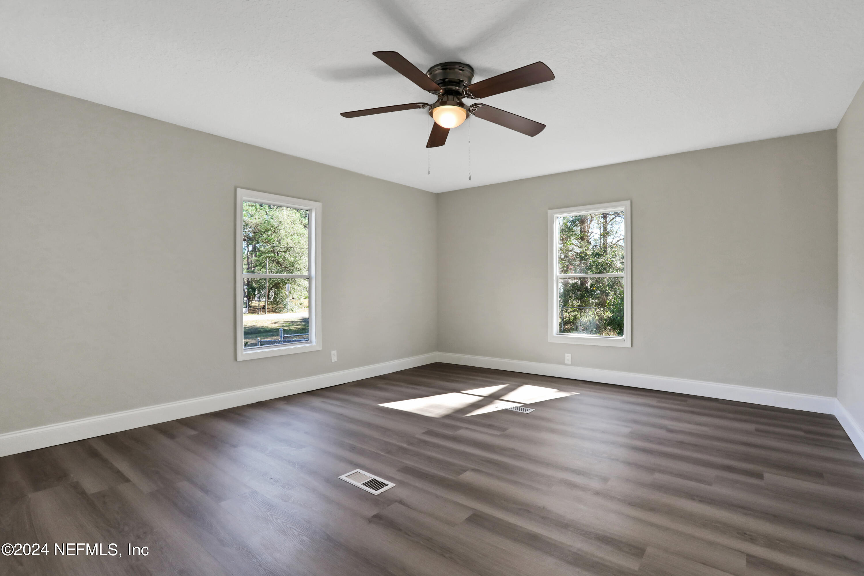 54057 Bea Road Callahan, FL 32011 - Photo 15 of 29 wooden floor in an empty room with a window