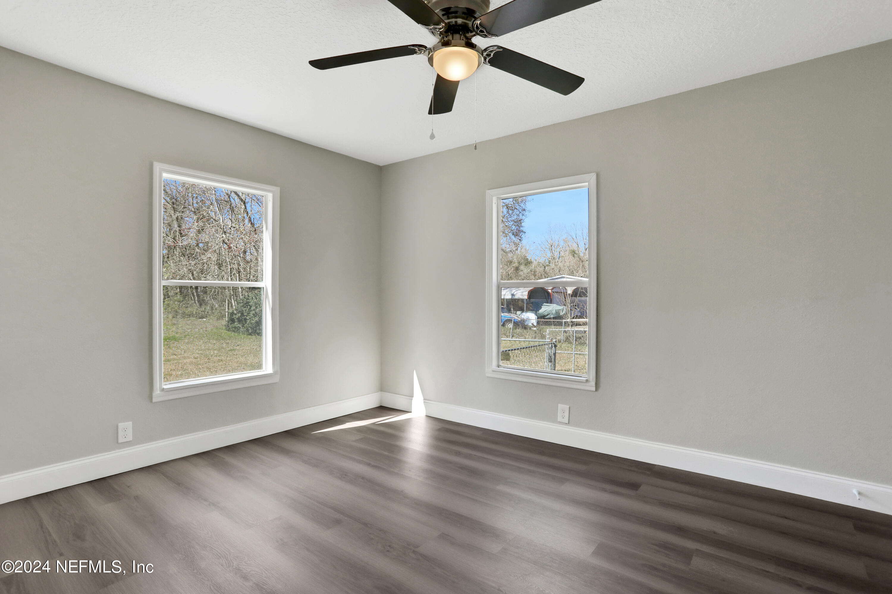 54057 Bea Road Callahan, FL 32011 - Photo 16 of 29 a view of an empty room with window and wooden floor