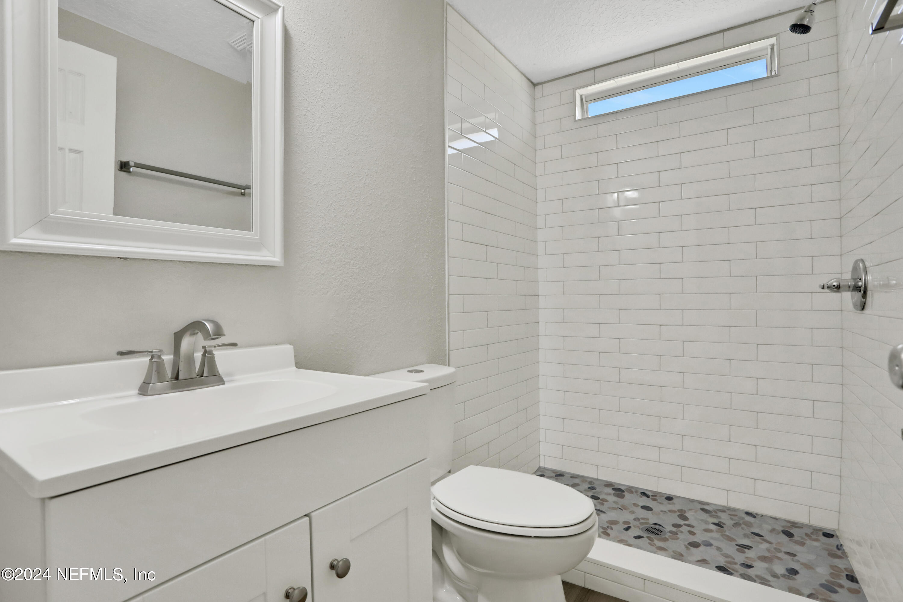 54057 Bea Road Callahan, FL 32011 - Photo 18 of 29 a bathroom with a sink toilet and mirror