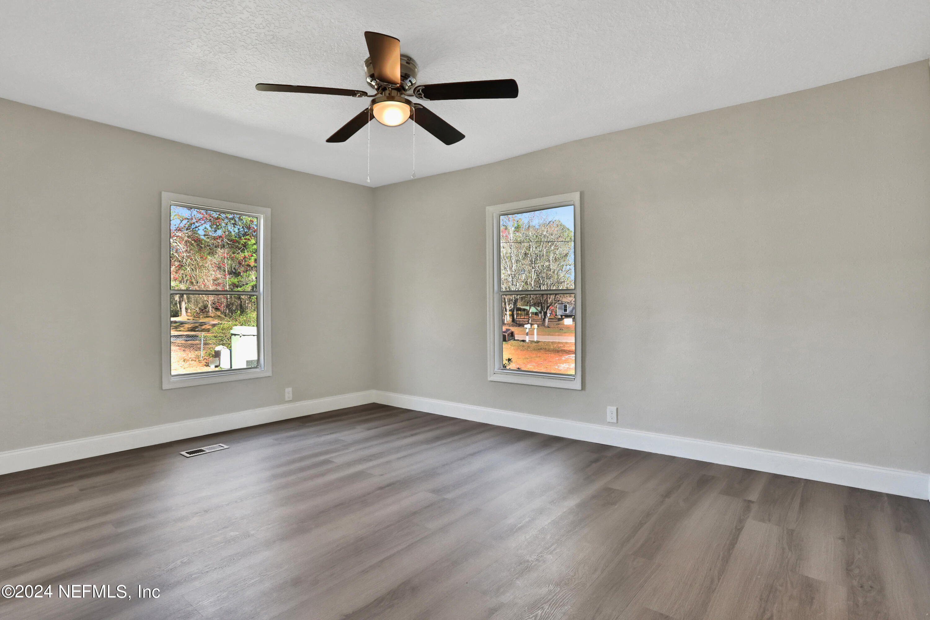 54057 Bea Road Callahan, FL 32011 - Photo 19 of 29 a view of an empty room with wooden floor and a window