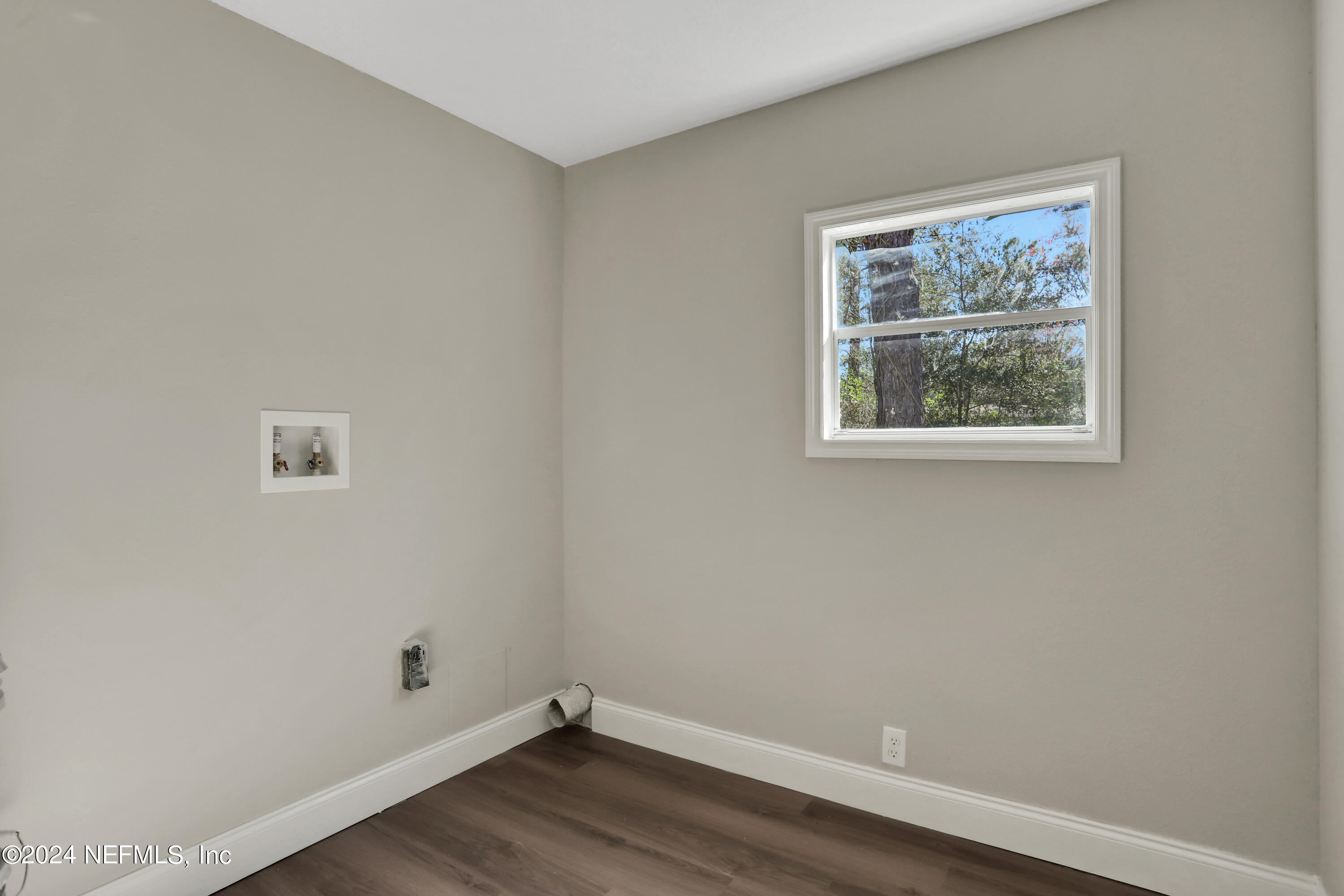 54057 Bea Road Callahan, FL 32011 - Photo 21 of 29 an empty room with a window and wooden floor