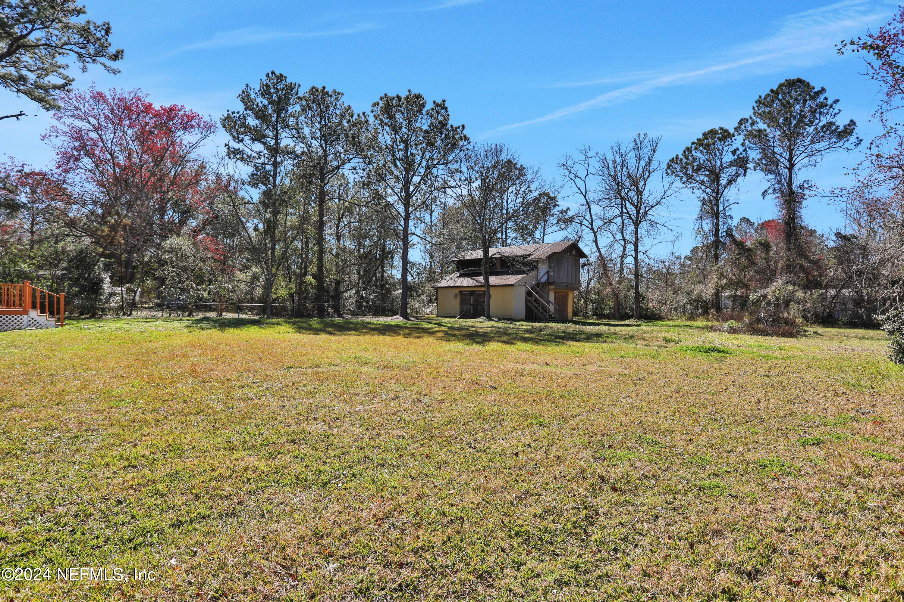54057 Bea Road Callahan, FL 32011 - Photo 22 of 29 a view of outdoor space with swimming pool and trees