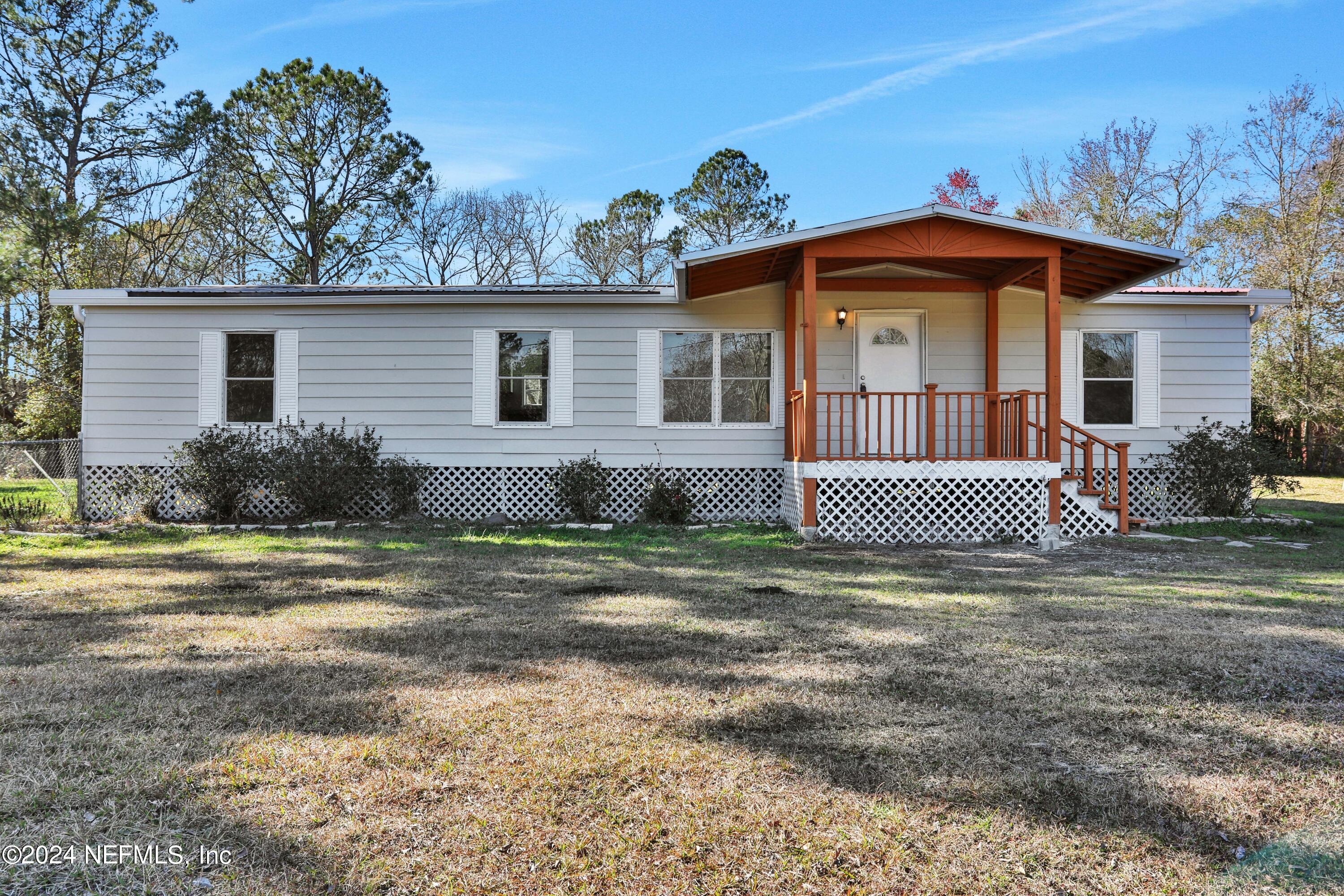 54057 Bea Road Callahan, FL 32011 - Photo 28 of 29 a view of a house with a yard